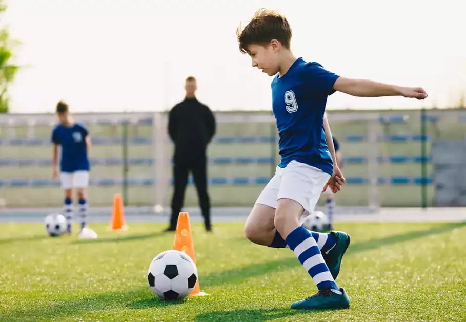 a young football player training